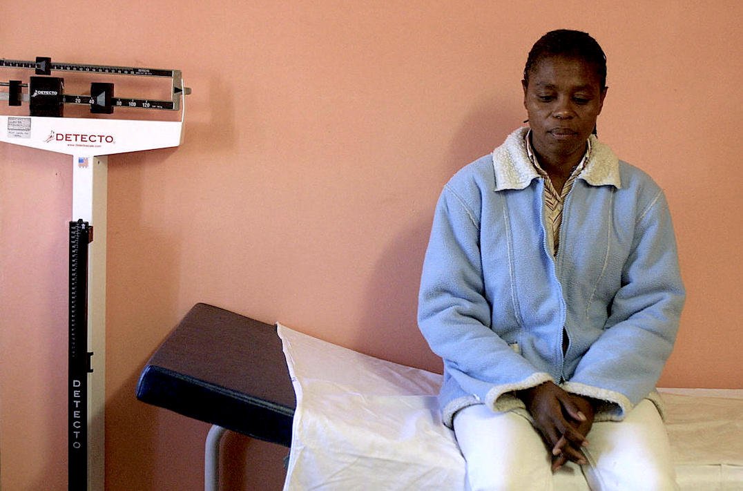 A woman waits to see a doctor in an HIV/AIDS clinic in Cape Town
